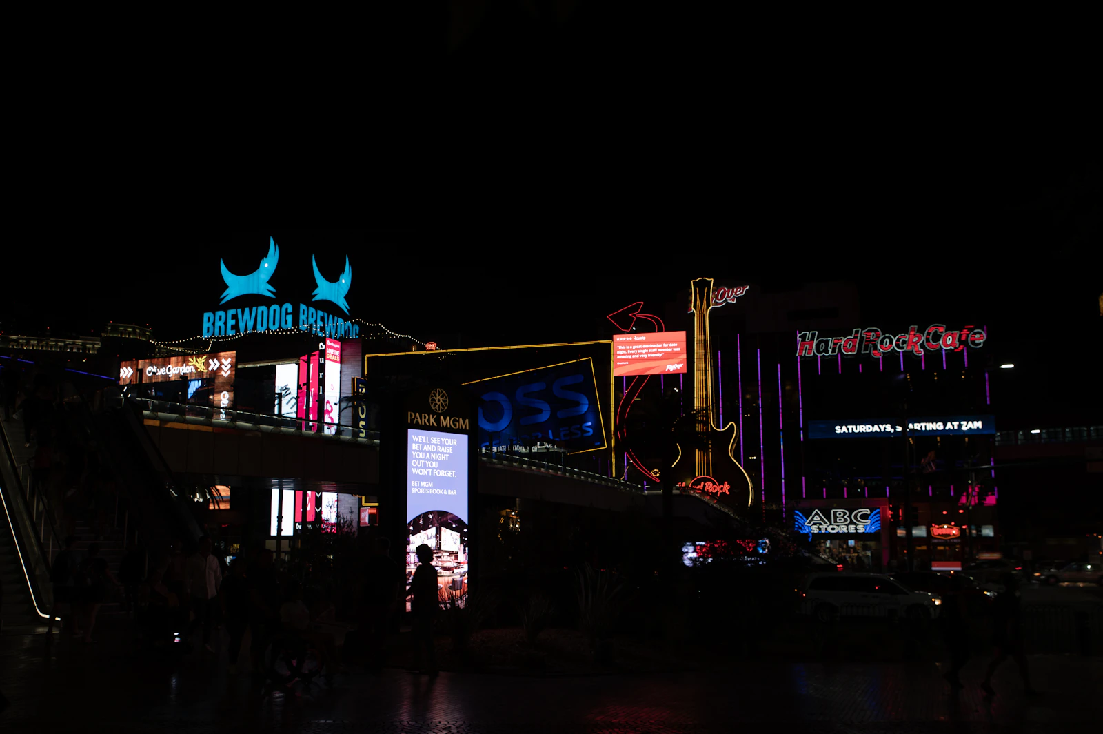A busy neon-lit city street at night