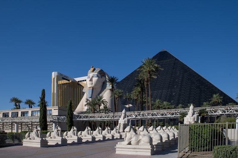 Grand Egyptian Museum exterior with Giza Pyramids in the distance