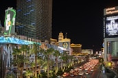 A lively street scene in Las Vegas with colorful lights and tourists.