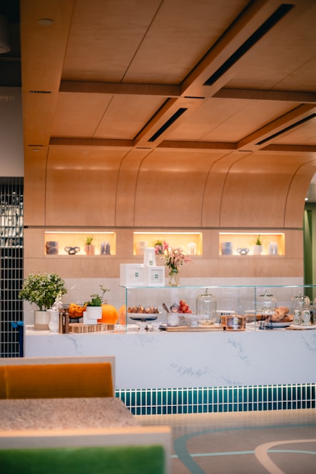 A cozy, inviting café counter with fresh sandwiches and vibrant fruit juices on display
