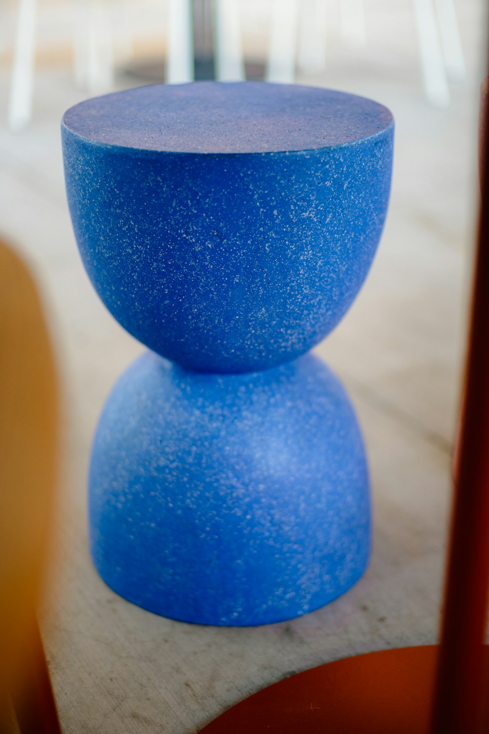 a blue vase sitting on top of a wooden table