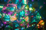 Vibrant and colorful reflections from mirrored glass surfaces create a kaleidoscope of light. Geometric patterns interlock in a mesmerizing display of hues.