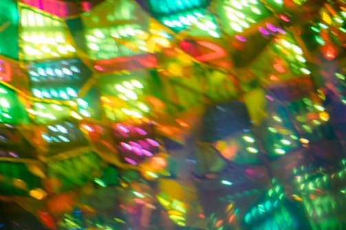 A colorful psychedelic folk art piece featuring bold lime green and purple patterns.