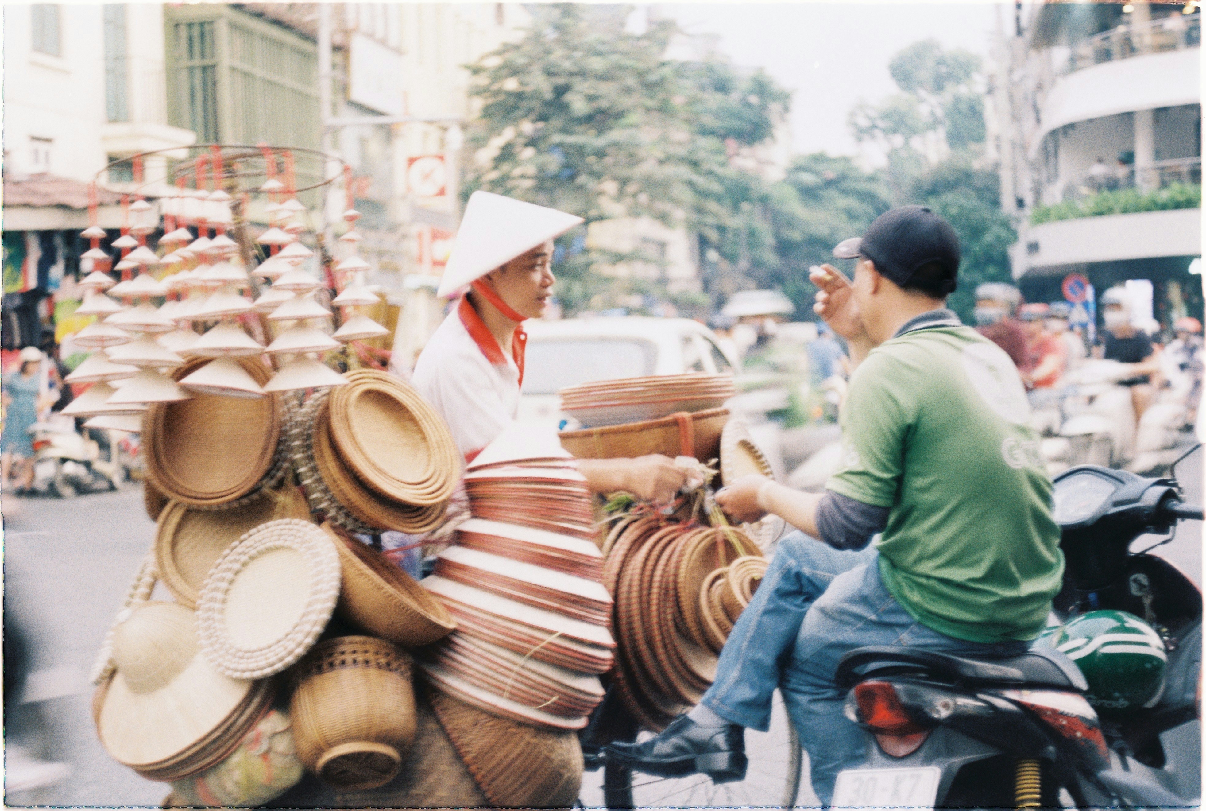 a man and a woman riding on the back of a motorcycle