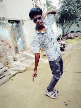 A casual model wearing a printed shirt enjoying an outdoor setting.