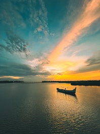 a small boat floating on top of a large body of water