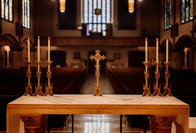 A serene image of a church altar adorned with flowers.