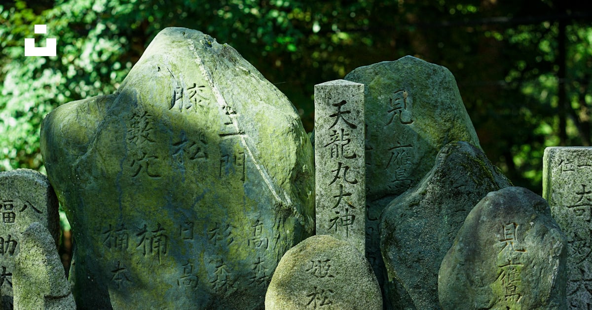 A group of rocks with asian writing on them photo – Free Kyoto Image on ...