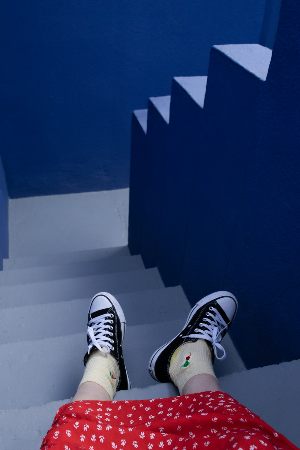 a person with their feet up on a stair case