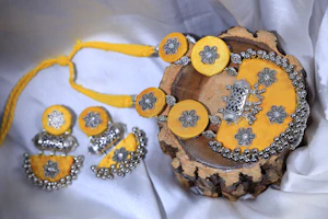 Bridal set featuring a radiant diamond necklace and matching bangles displayed elegantly on a white silk cloth