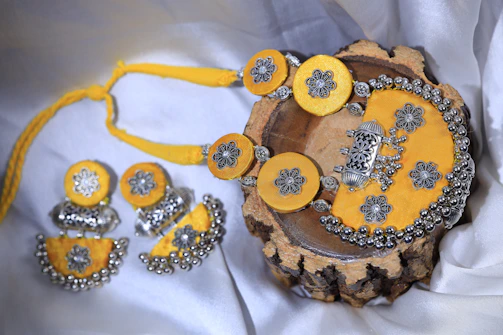 Bridal set featuring a radiant diamond necklace and matching bangles displayed elegantly on a white silk cloth