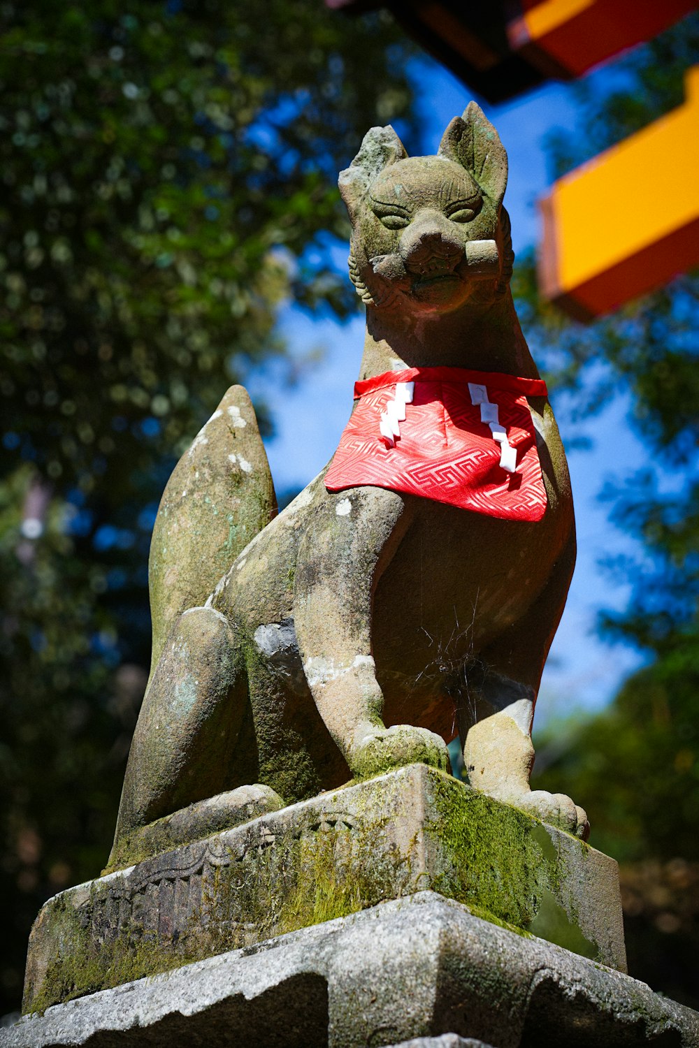 a statue of a dog with a bandanna around its neck