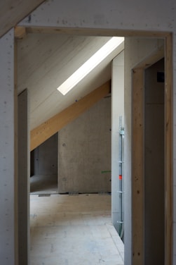 A skilled builder working on a modern loft conversion in a London home.