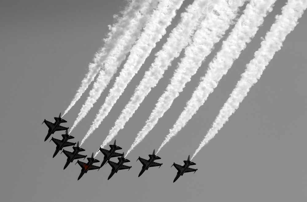 a group of fighter jets flying in formation