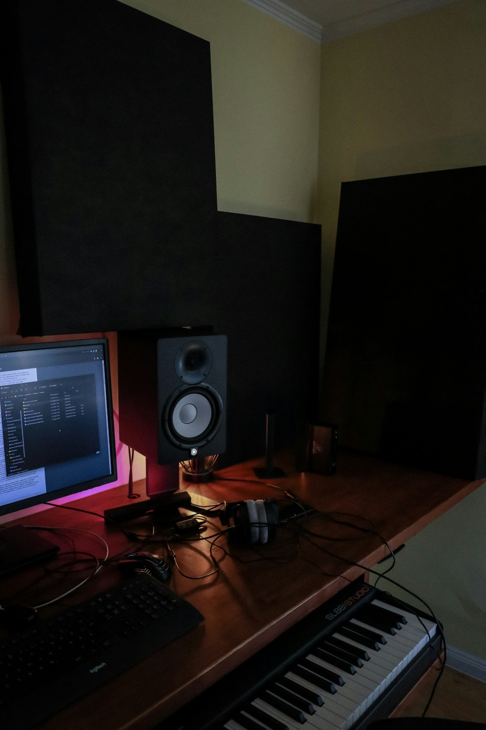 a desk with a keyboard and a monitor