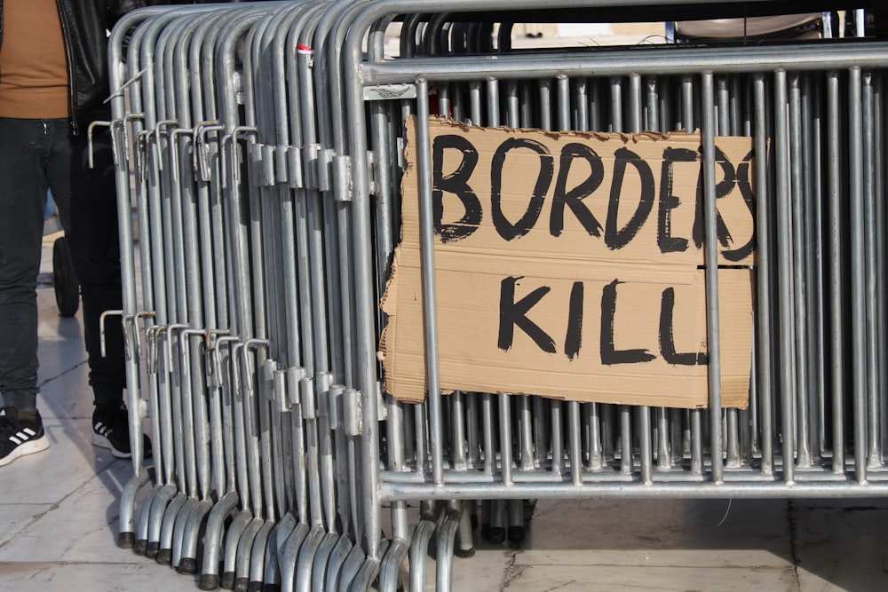 a sign on a fence that says border kill