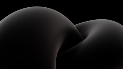 Minimal 3D geometric shapes with subtle highlights against a dark background.