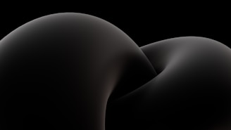 Close-up of a smooth, curved digital form with reflective surfaces in muted tones.