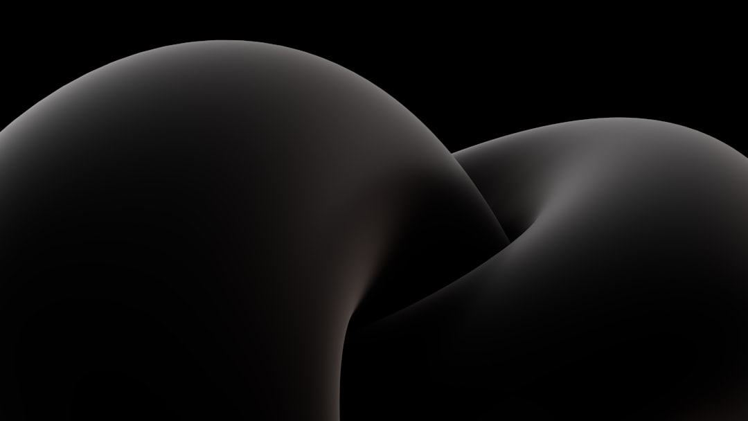 a black background with a black object in the middle of it, Captivating.