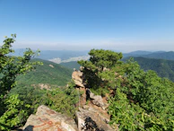 Scenic view of the Serra do Cipó mountains near Santa Bárbara with lush greenery under a clear sky.