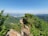 A scenic view of a popular travel destination with clear blue skies and lush greenery.