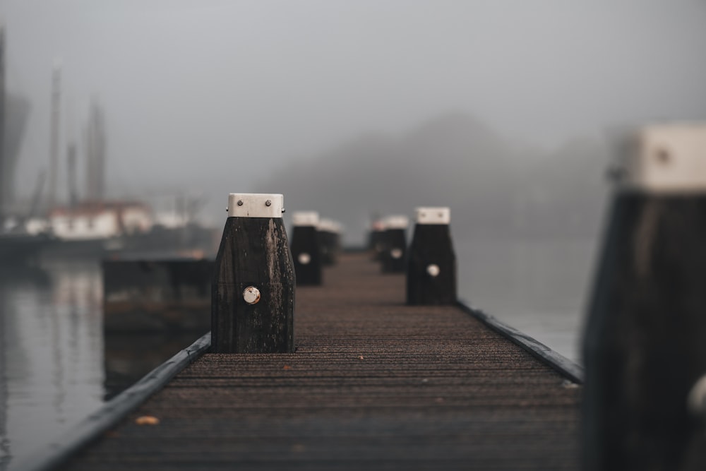 a dock with a few boats on it on a foggy day