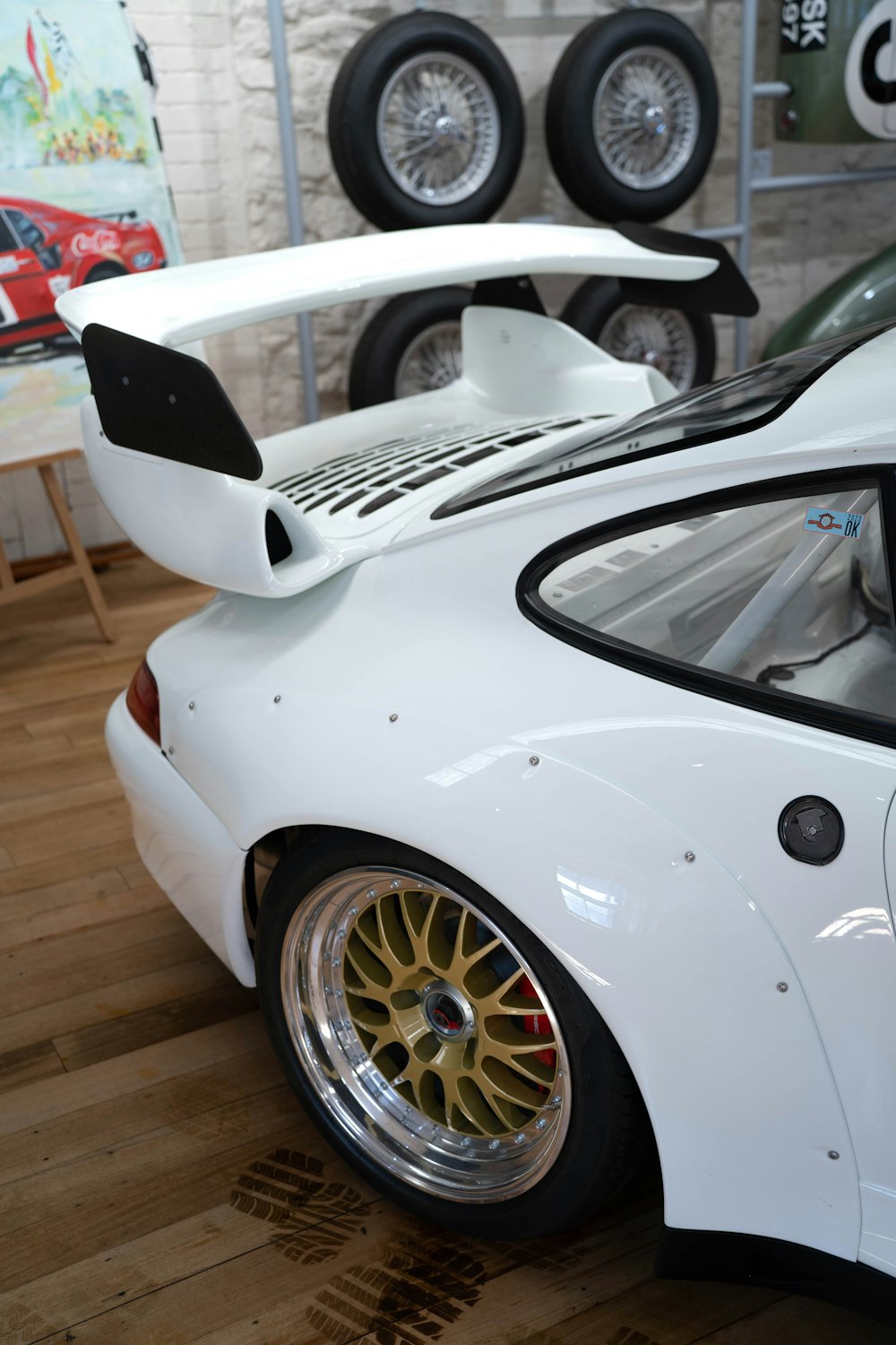 a white sports car parked in a showroom