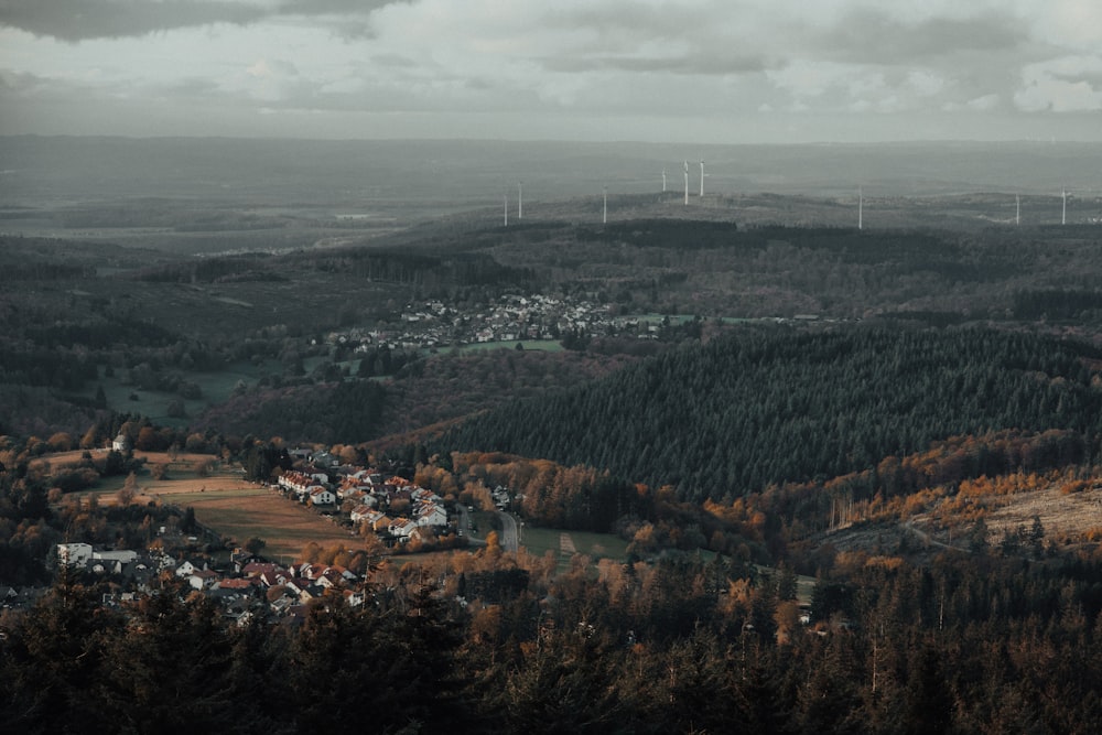 a view of a valley with wind mills in the distance