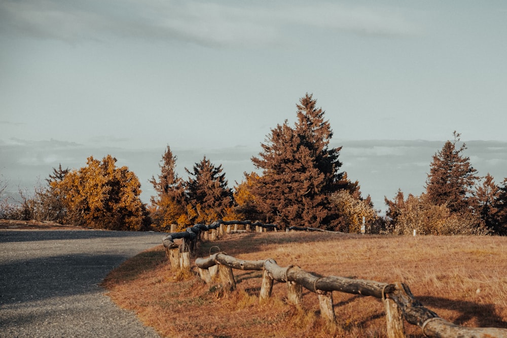 a wooden fence in the middle of a field