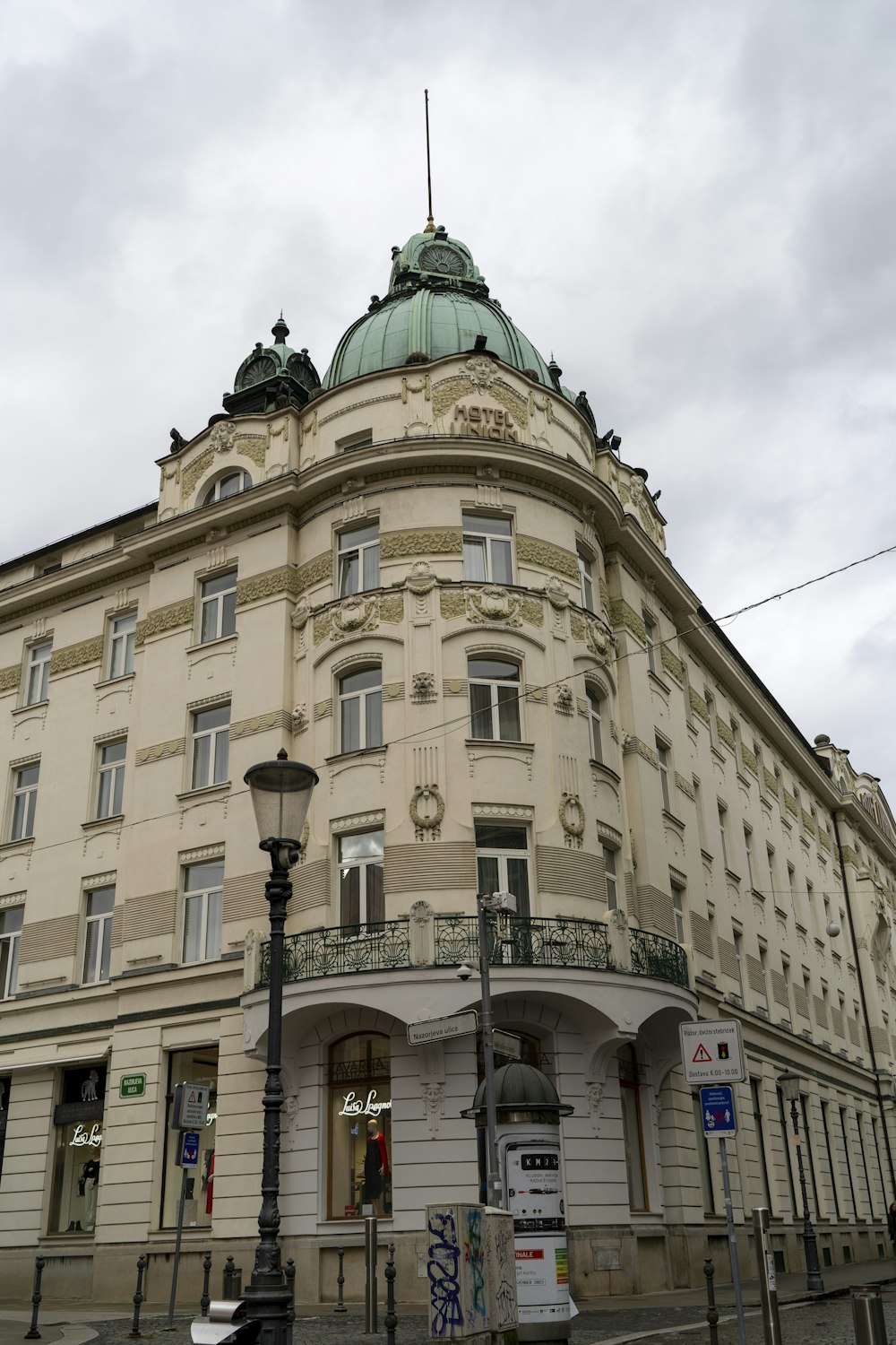 a tall building with a green dome on top of it