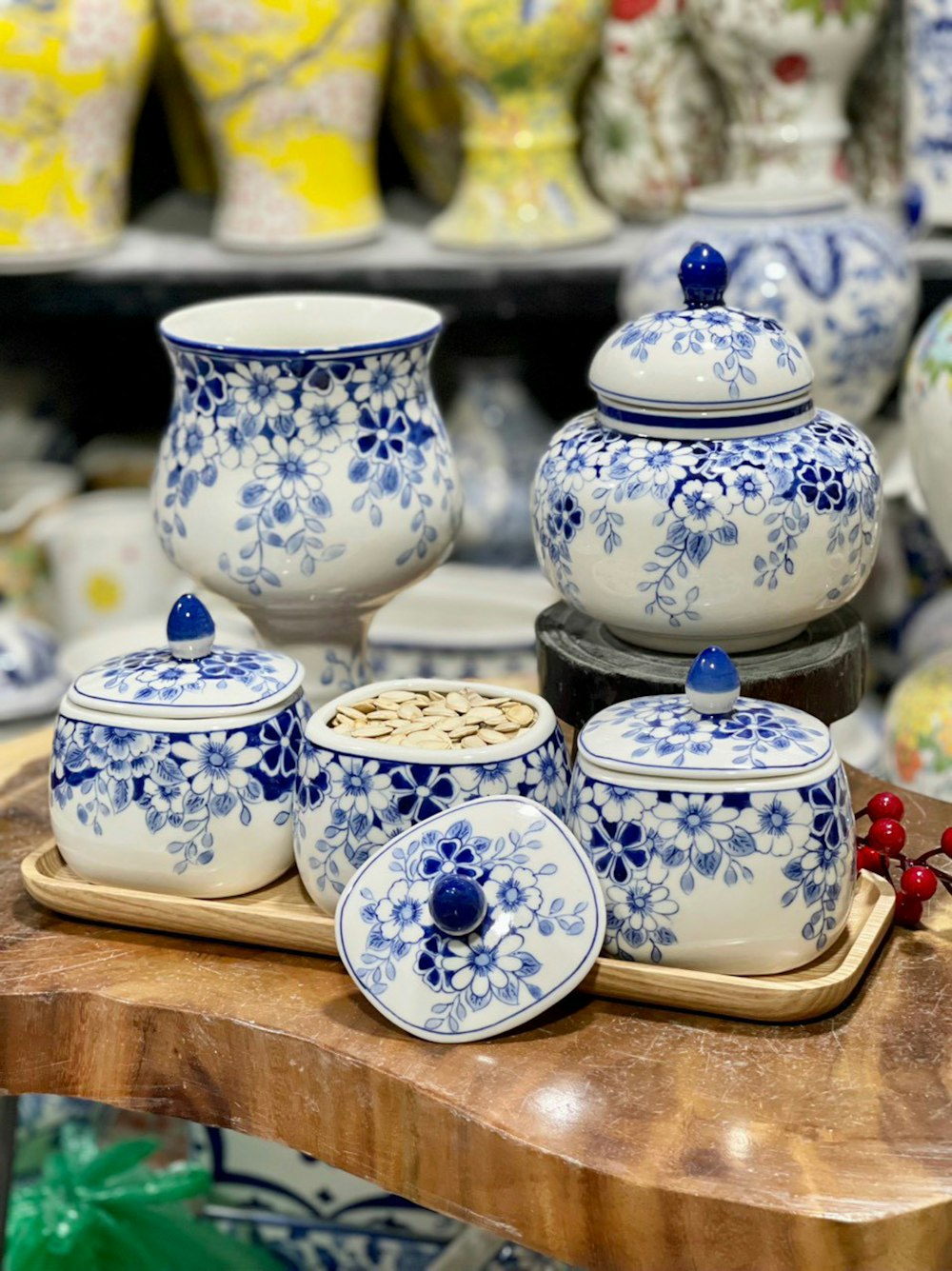 a wooden table topped with lots of blue and white dishes