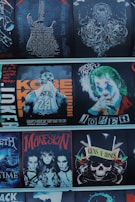 A collection of graphic images featuring various themes and personalities, including a detailed guitar design with text, an octopus illustration, a basketball player with the name 'Kobe,' a character resembling a clown with makeup, four individuals with dark makeup and hairstyles in a rock band style, and a skull with roses and guns symbolizing a famous rock band.