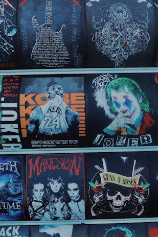 A collection of graphic images featuring various themes and personalities, including a detailed guitar design with text, an octopus illustration, a basketball player with the name 'Kobe,' a character resembling a clown with makeup, four individuals with dark makeup and hairstyles in a rock band style, and a skull with roses and guns symbolizing a famous rock band.