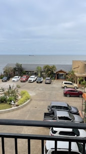 Spacious parking area with cars parked near the hotel entrance.