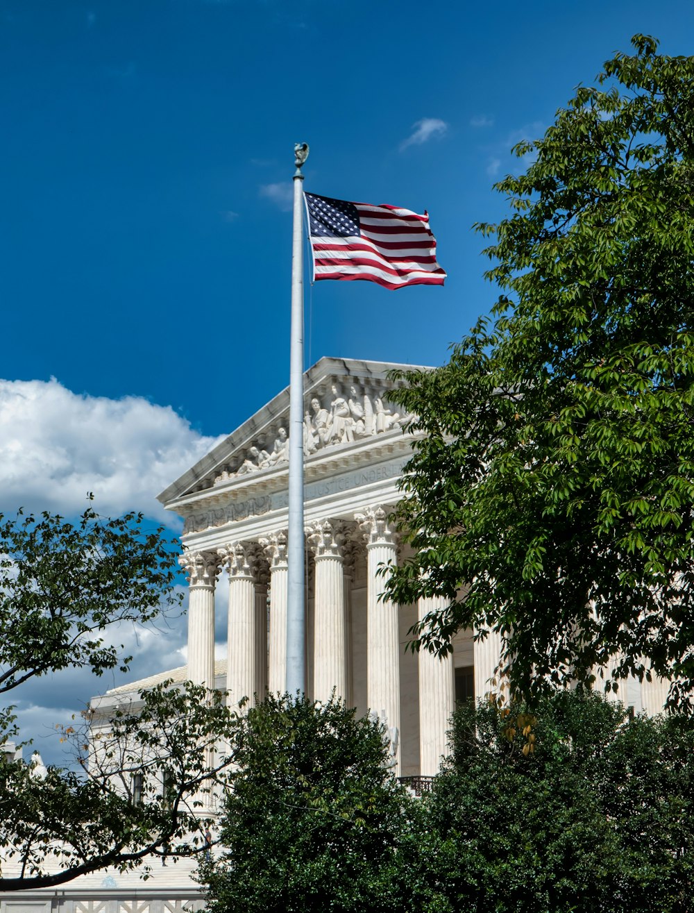 an american flag flying in front of a building