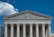 The image presents the facade of a neoclassical building with grand columns and intricate sculptures atop the pediment. The structure is made of stone, and the frieze bears the inscription 'EQUAL JUSTICE UNDER LAW.'