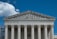 The image presents the facade of a neoclassical building with grand columns and intricate sculptures atop the pediment. The structure is made of stone, and the frieze bears the inscription 'EQUAL JUSTICE UNDER LAW.'