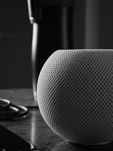 Close-up of a sleek, futuristic speaker cone glowing softly under cinematic studio lighting with subtle reflections.