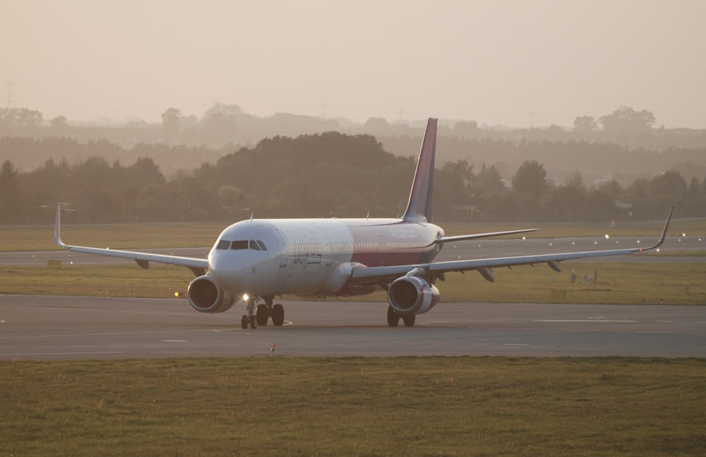 a large jetliner sitting on top of an airport runway