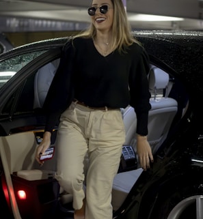 a woman walking out of a car in a parking garage