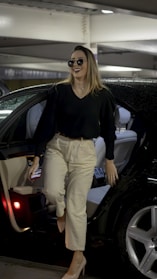 a woman walking out of a car in a parking garage