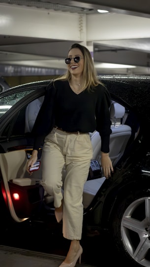 a woman walking out of a car in a parking garage
