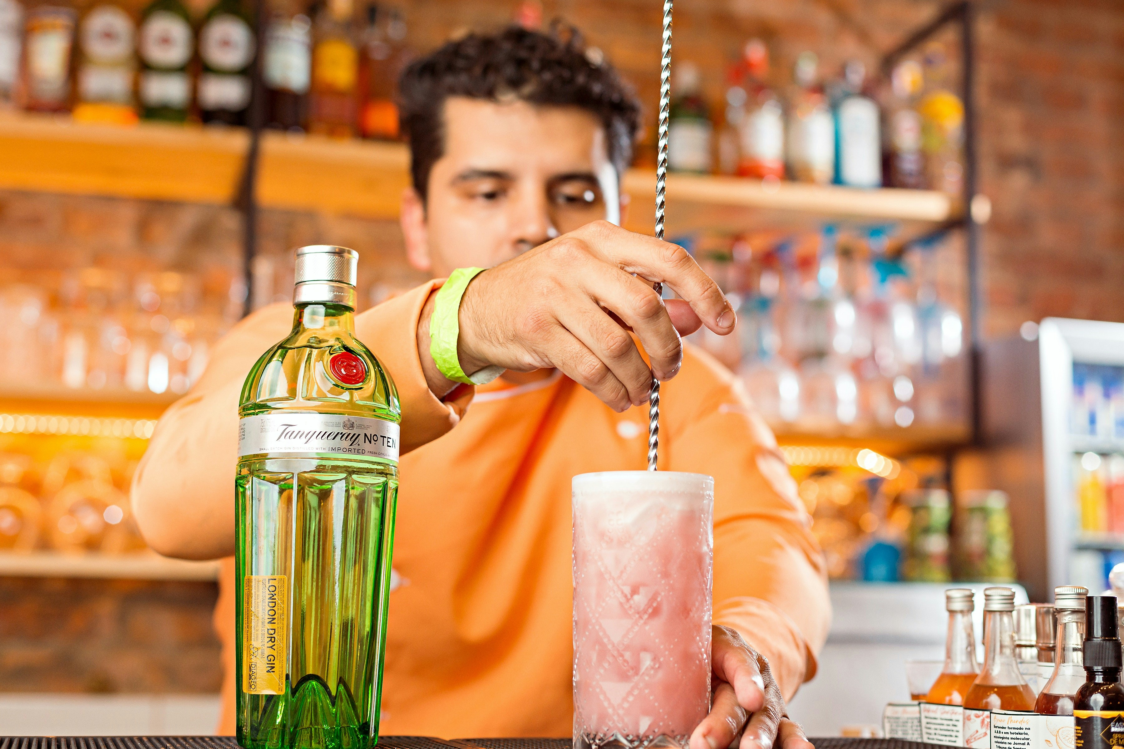a man making a drink at a bar