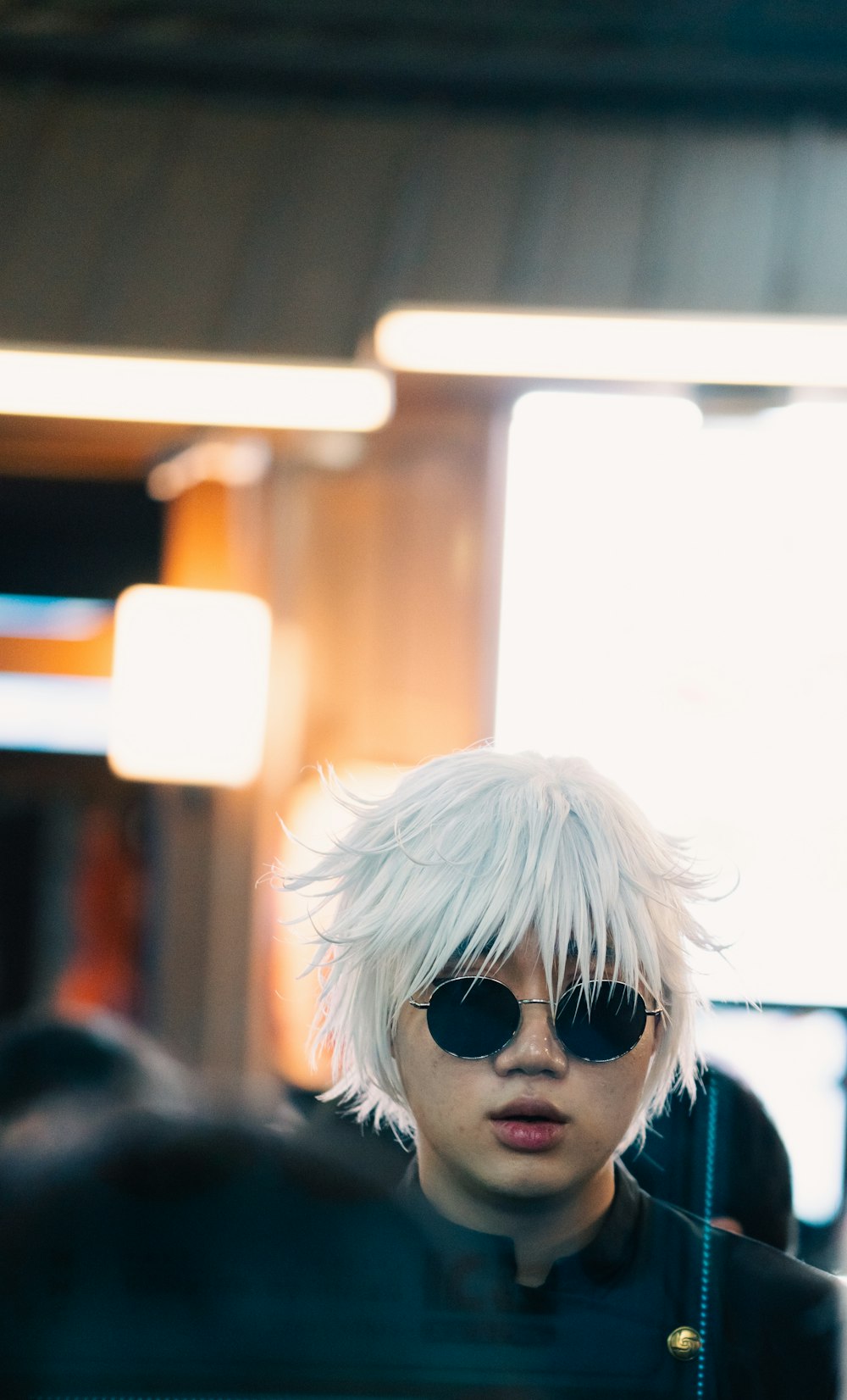 a person with a white hair and sunglasses