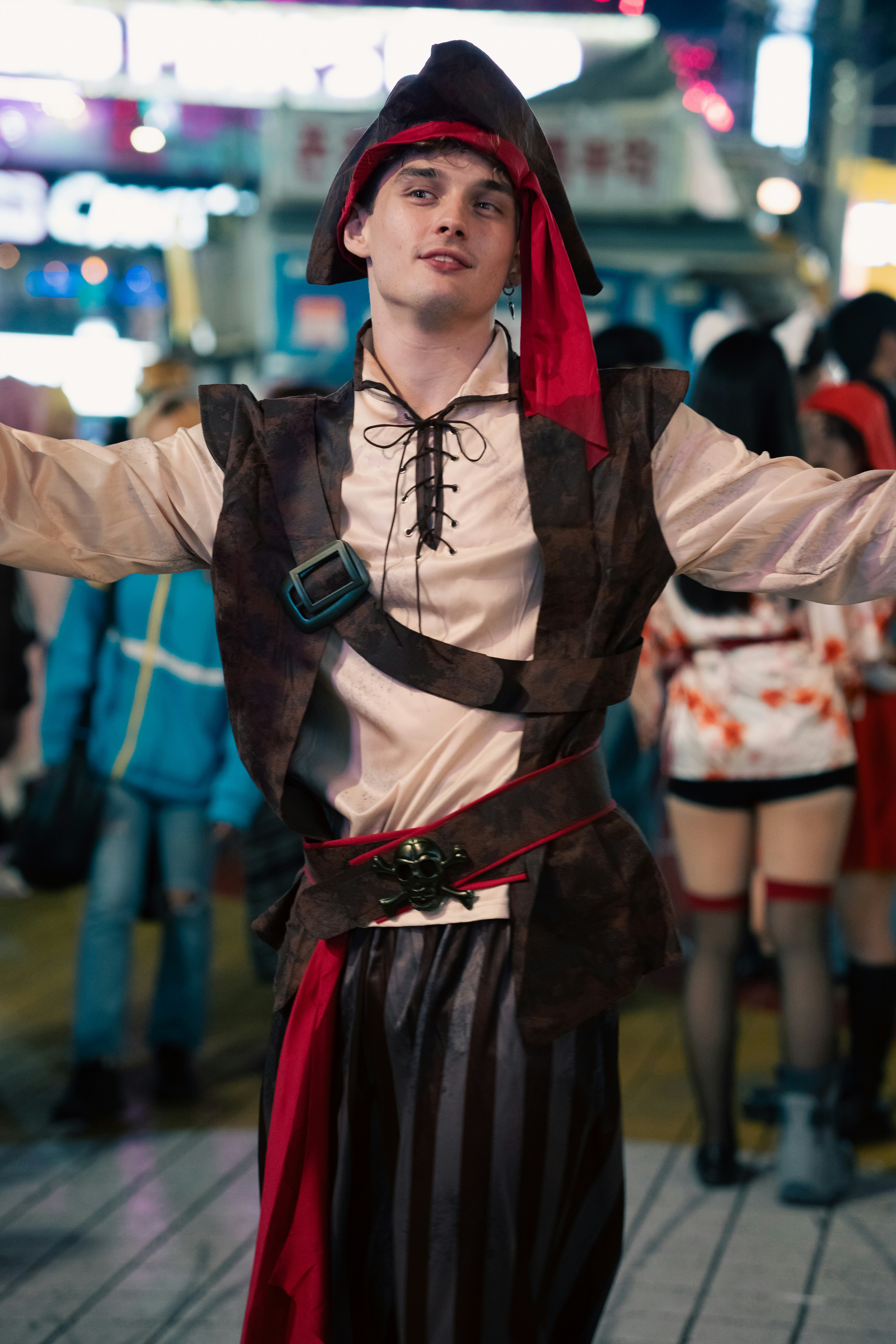 a man in a pirate costume standing on a sidewalk