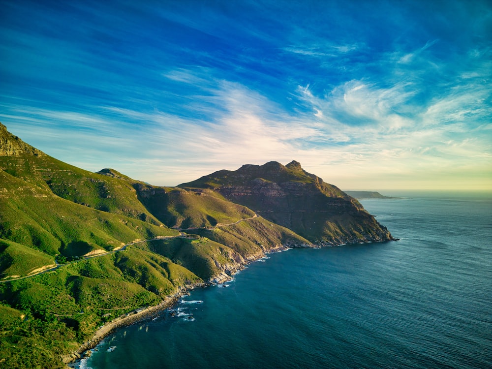 a scenic view of the ocean and mountains