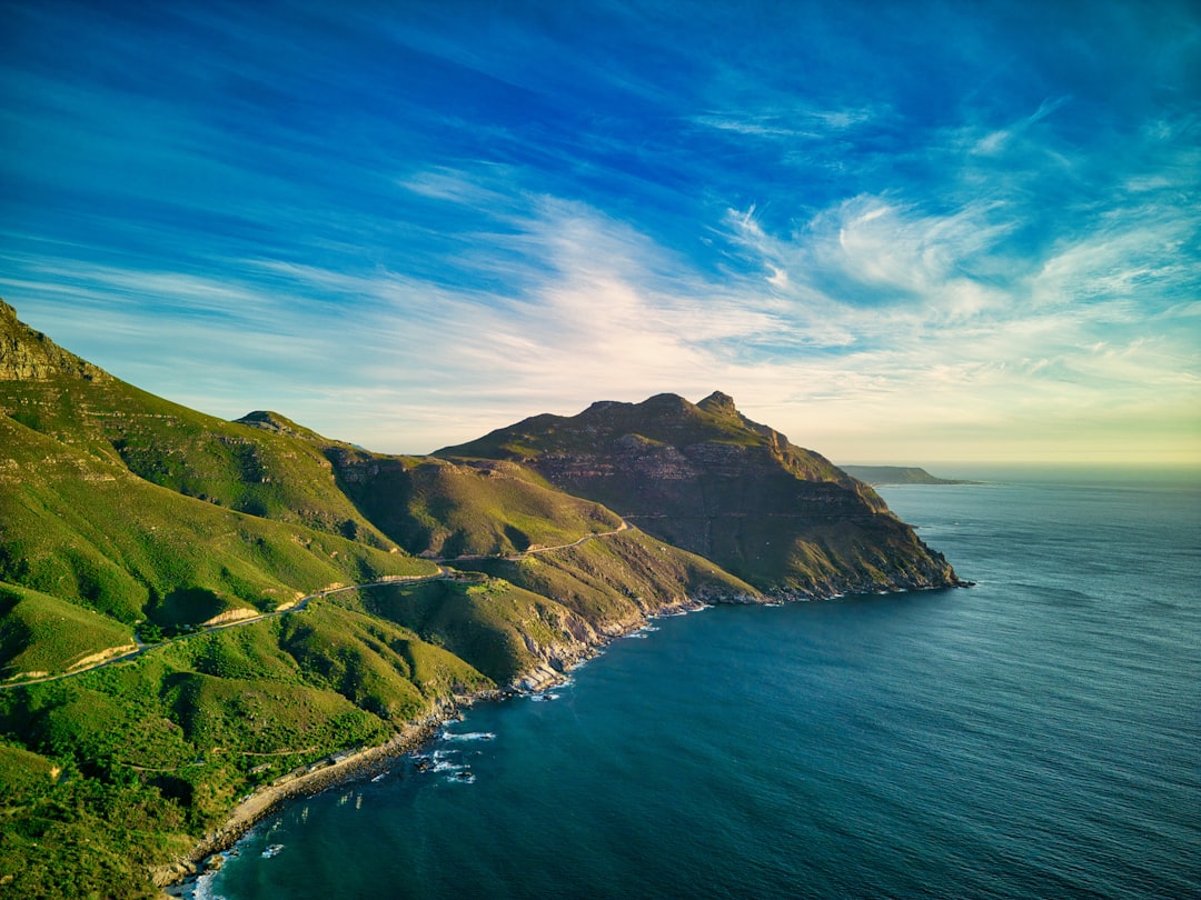 a scenic view of the ocean and mountains,