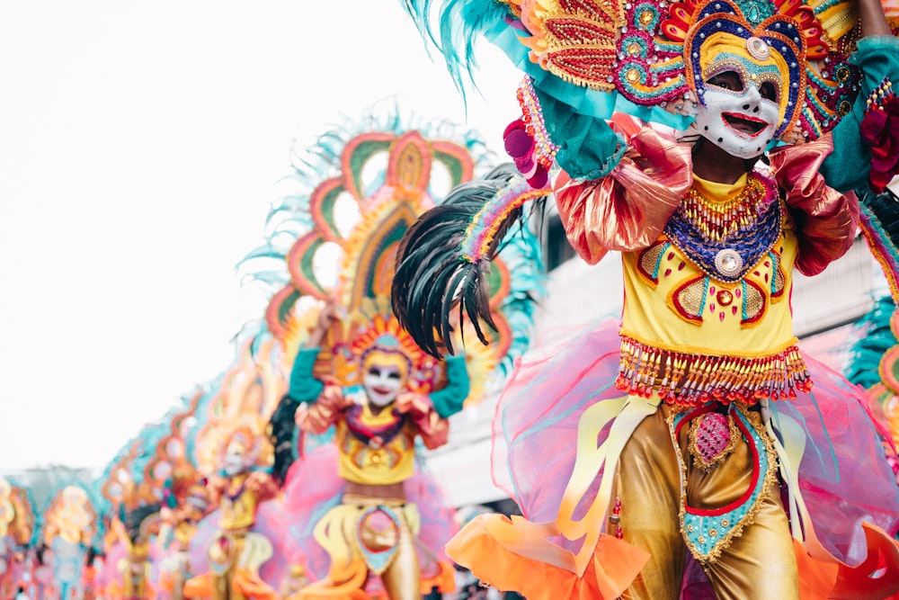 a group of colorfully dressed people walking down a street