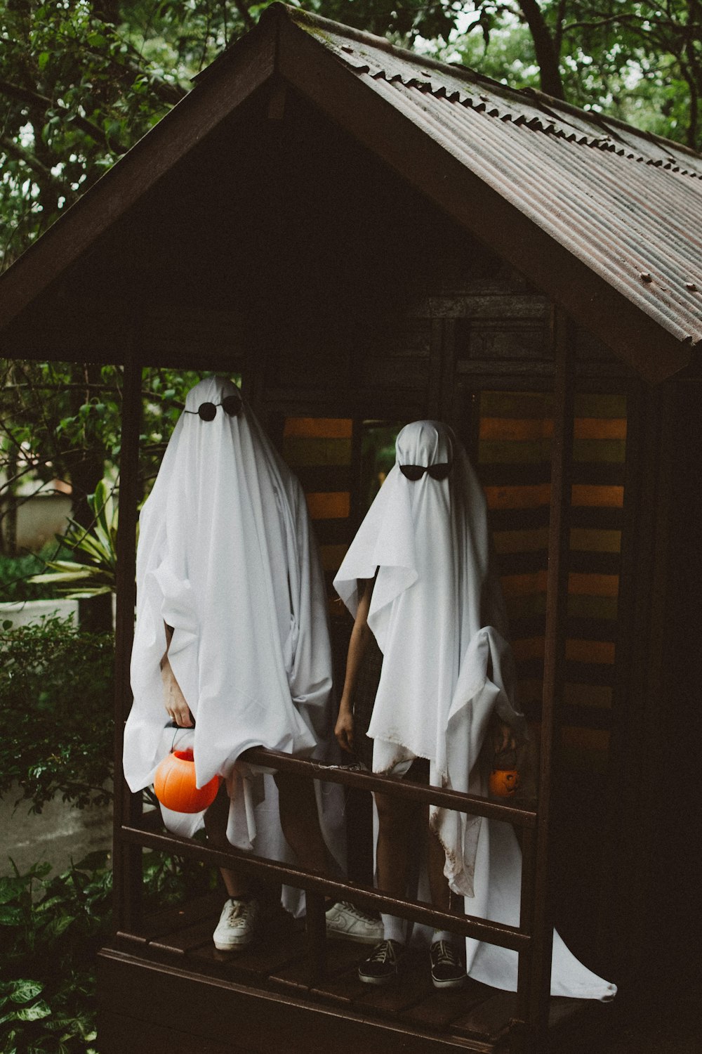 a couple of people dressed up in ghost costumes