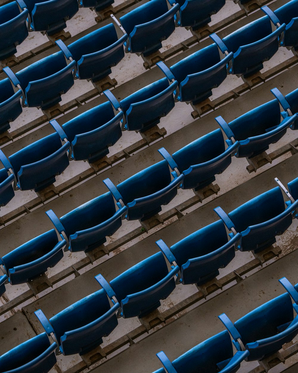 a row of blue seats sitting next to each other